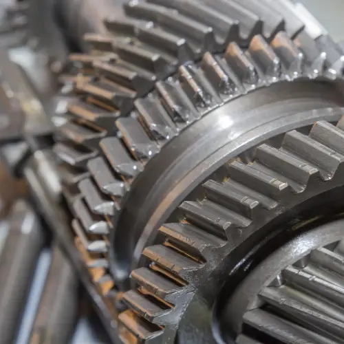 Close-up view of interlocking metal gears with detailed teeth in a mechanical system.
